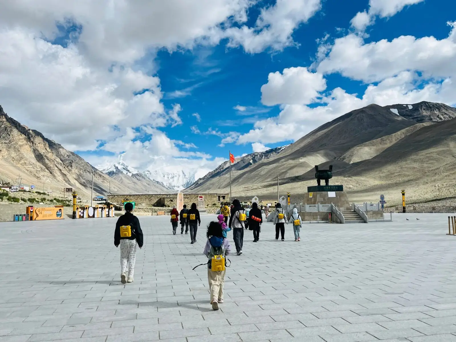 At Everest Base Camp, a popular tourist destination in Tibet, you can rent oxygen; the yellow canisters that the visitors are carrying on their backs are oxygen tanks.