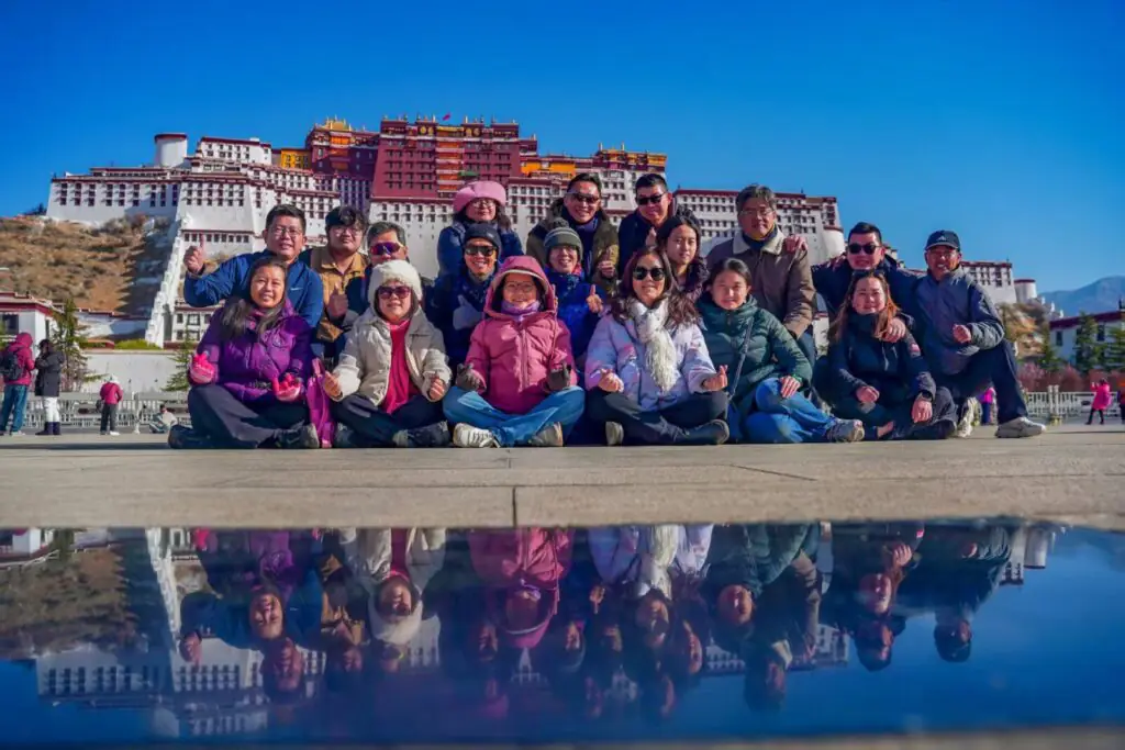 CITS中國國旅環球-China2Go 西藏旅遊團旅客在拉薩布達拉宮前合影,冬日藍天與水面倒影